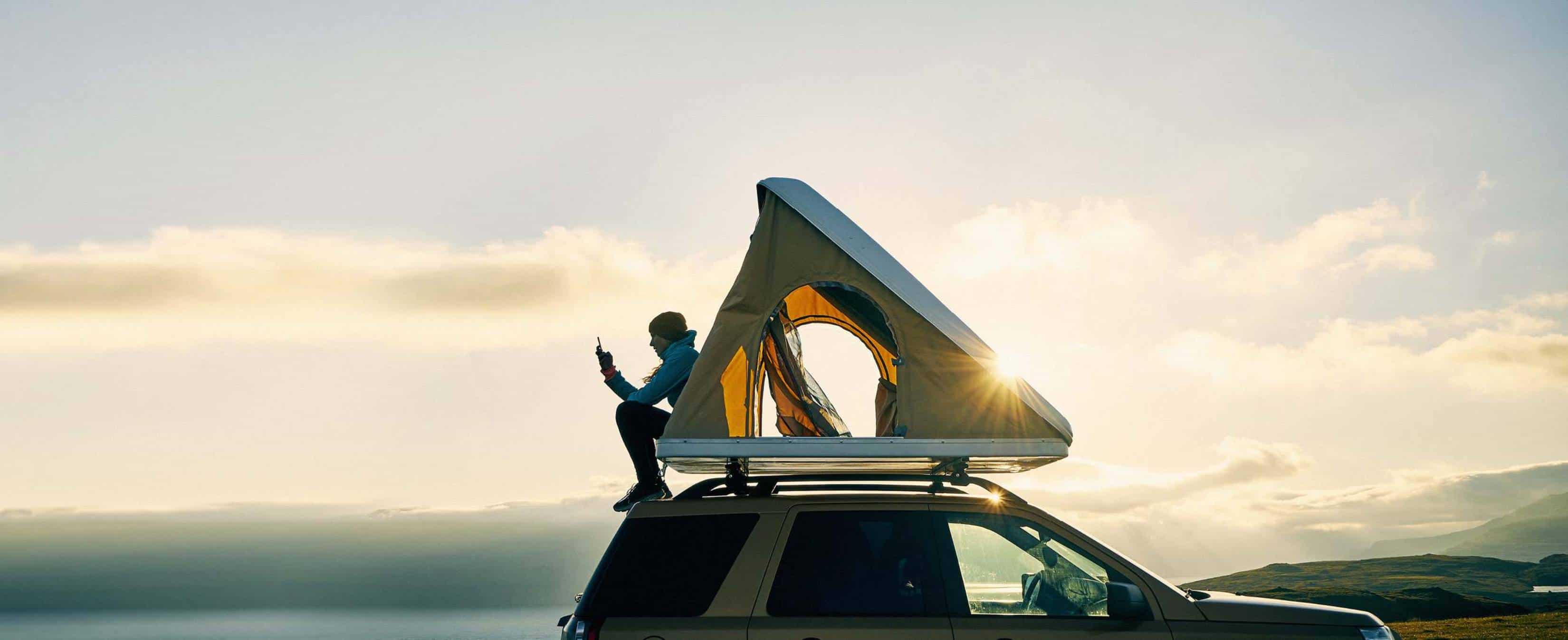 Person sitting on car boot