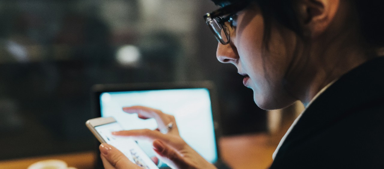 Image shows a person using a mobile