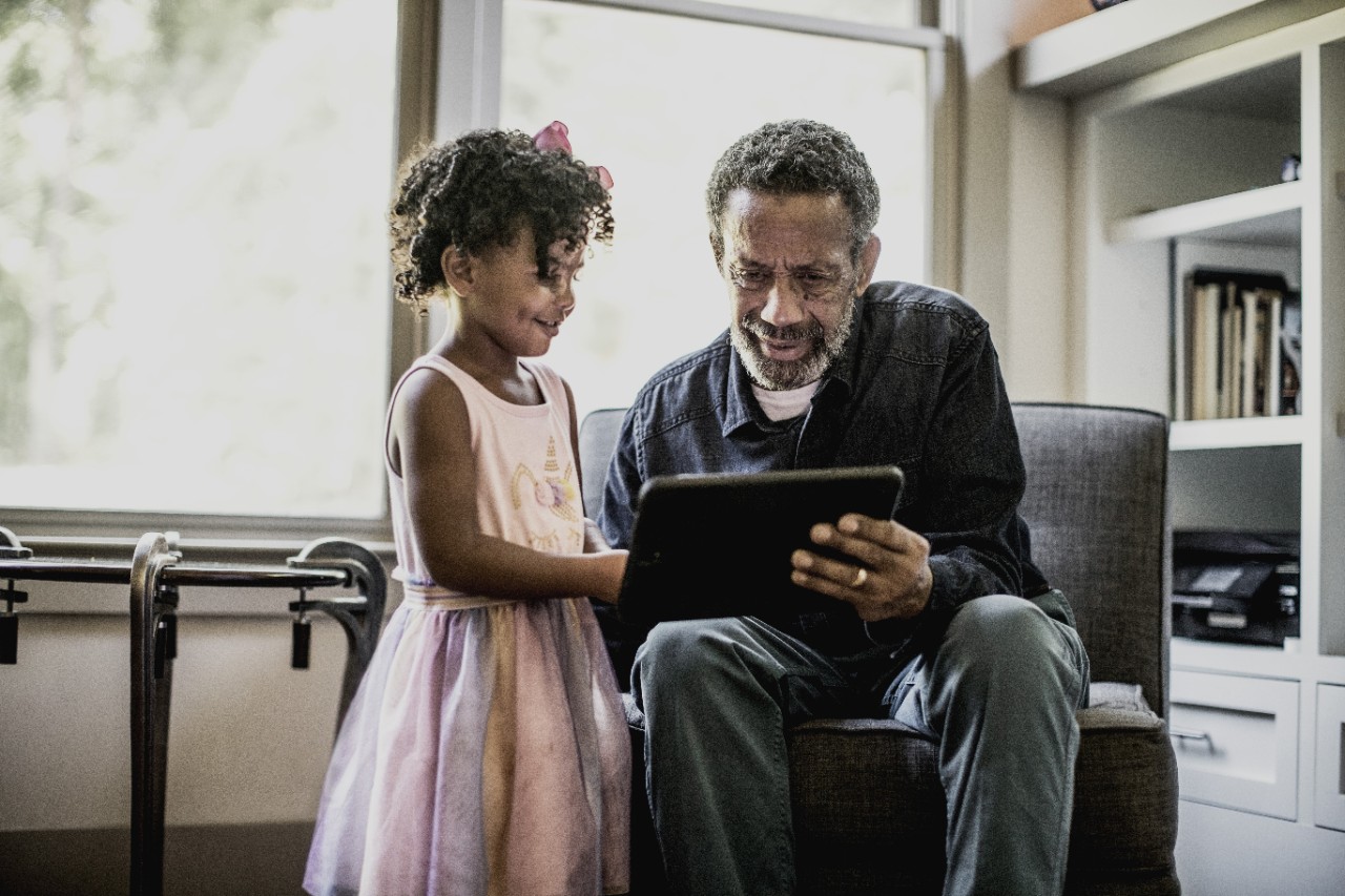 Grandaught and grandad on a tablet