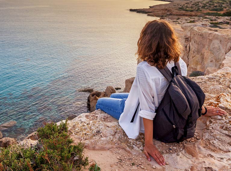 Women sat on clift over looking sea image