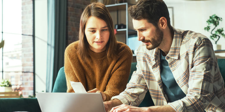 Man and woman looking at laptop.