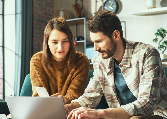 Man and woman looking at laptop.