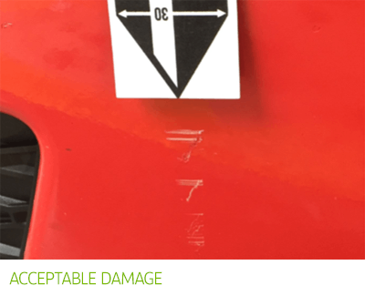 Acceptable damage - red car with scratches on it.