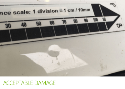Acceptable damage - white car with small dent.