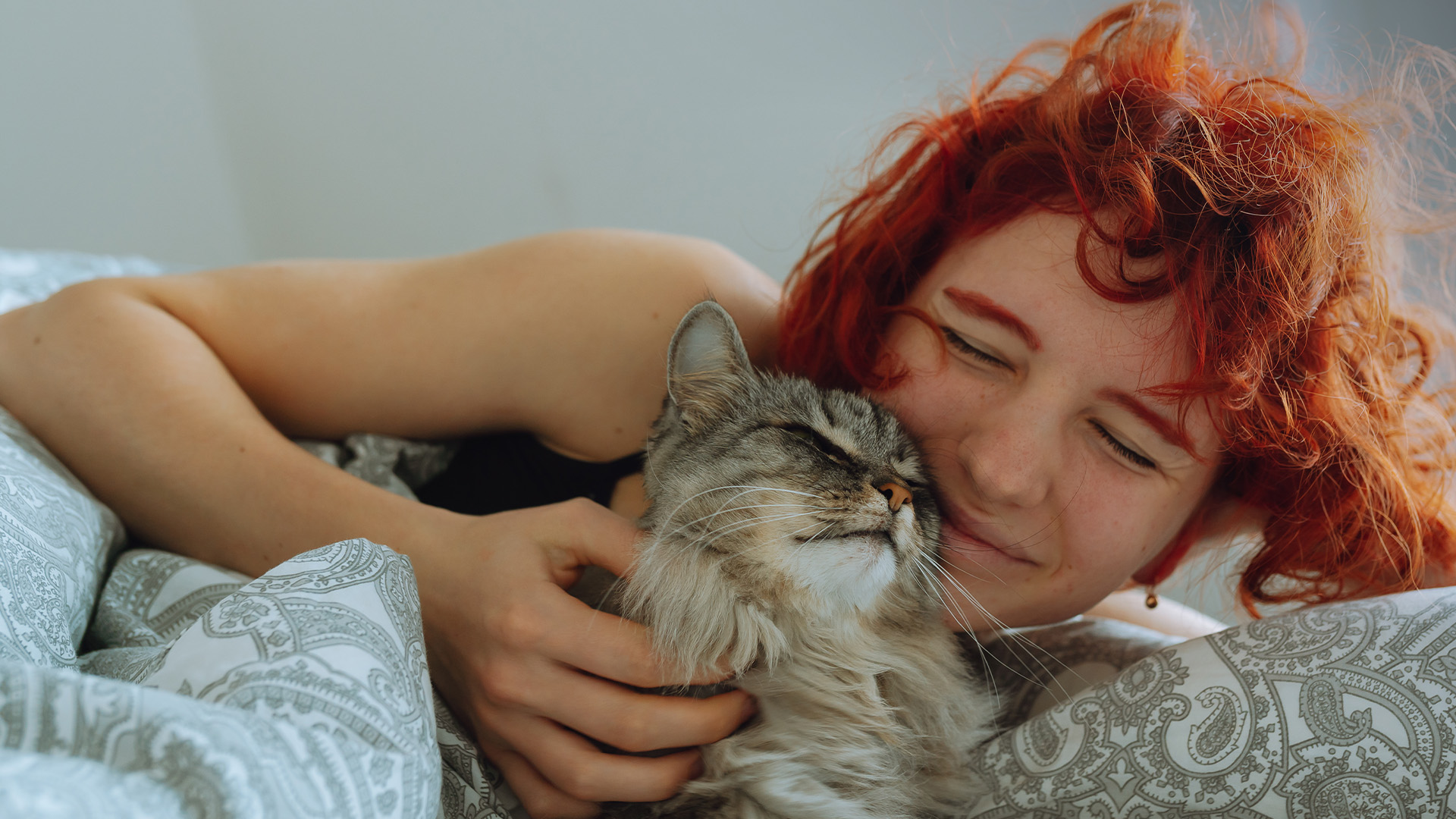 A woman kissing her dog