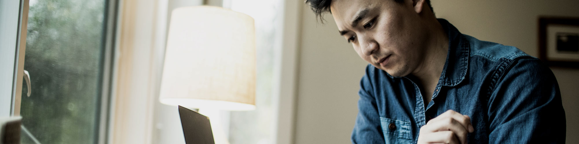 Man looking down on phone