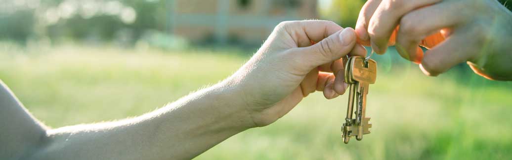 New homeowners being handed a set of house keys