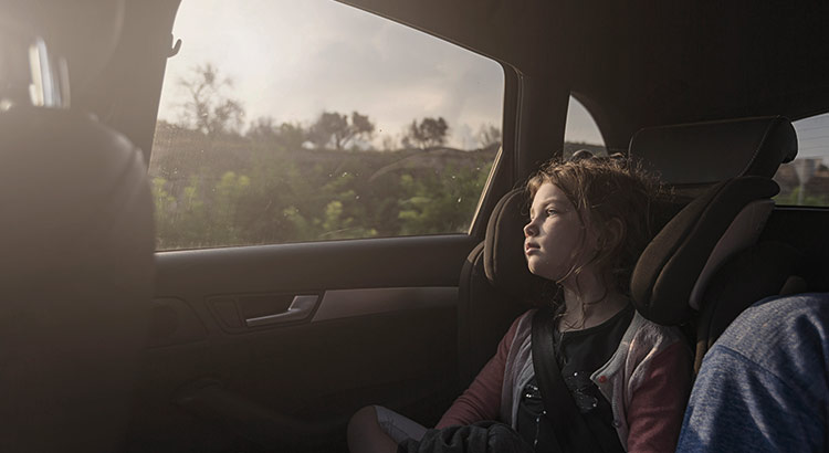 Child looking out of a car window
