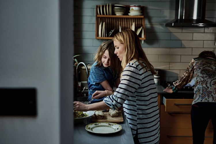 Family preparing food in kitchen
