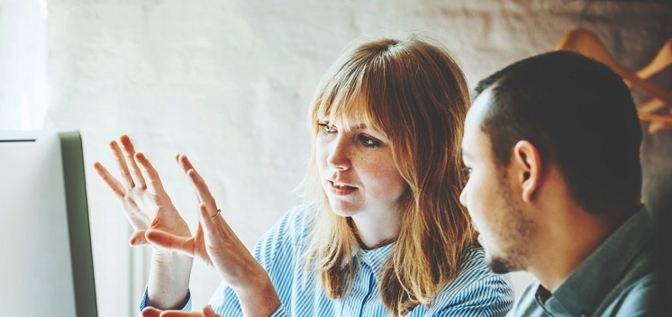 2 people discussing designs