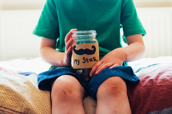 A young person with a coin jar