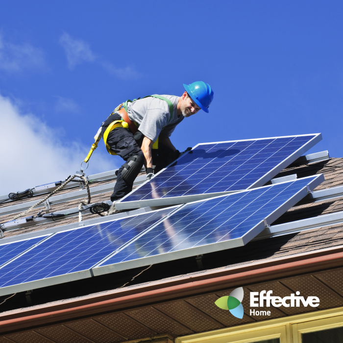 A man installing the solar panels on a roof