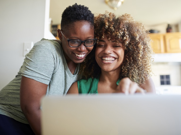 Two women looking at a laptop.
