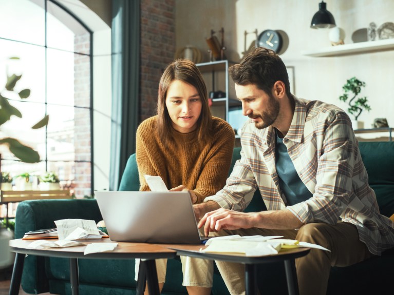 Man and woman looking at laptop.