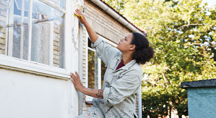 Woman painting a wall