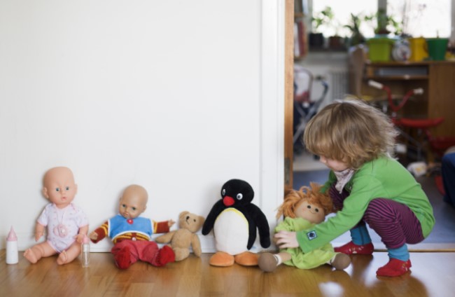 Child playing with their toys and dolls