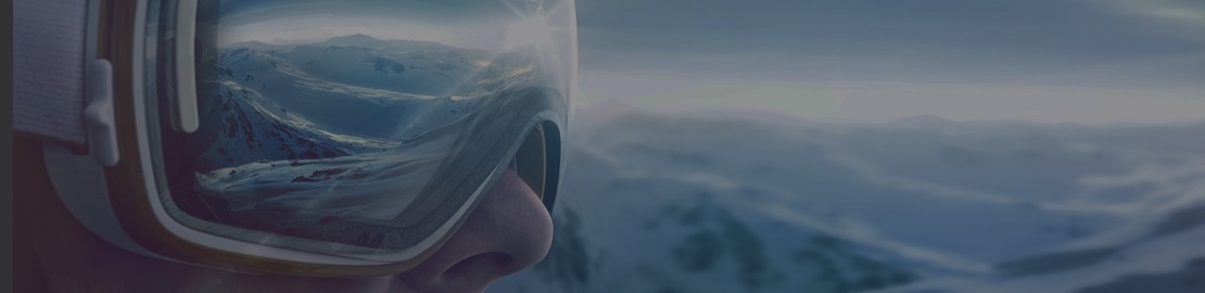 Skier looking towards snowy mountains