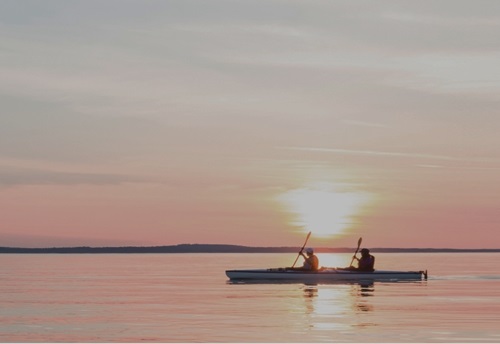 Horizon view of of lake and conoeing boat