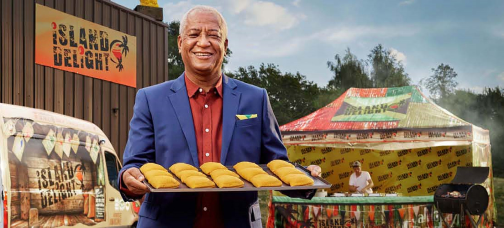 Person presents dishes from Island Delight