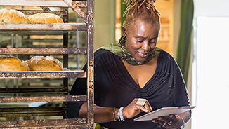 woman in bakery using ipad