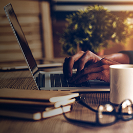 person at desk working on laptop