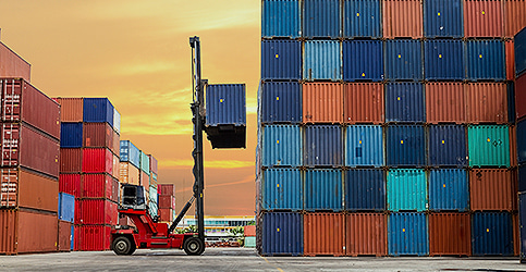 forklist lifting shipping container at dockyard