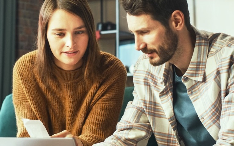 An image of a man and woman reviewing their finances.