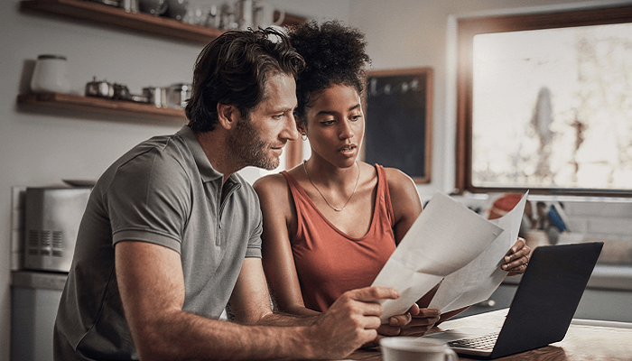 An image of a couple reviewing financial documents
