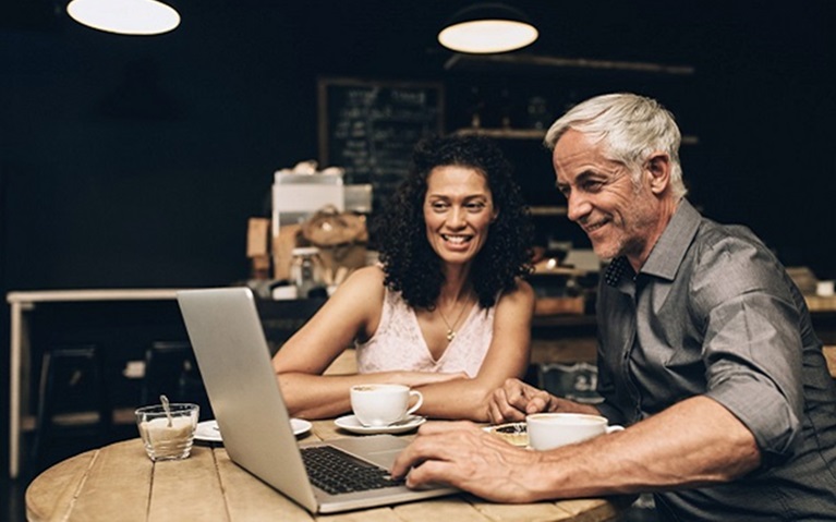An image of a middle aged couple reviewing their finances together.