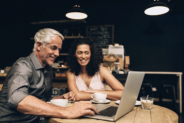An image of a middle-aged couple reviewing their pension options together.